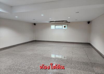 Spacious empty room with tiled flooring and high ceiling