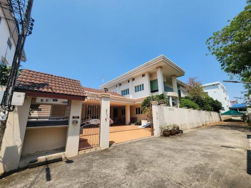 Spacious two-story house with large driveway and surrounding fence