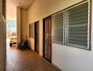 Entrance of a residential building with tiled flooring and wooden door