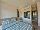 Spacious bedroom with modern design, scenic view, and ample lighting