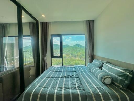 Spacious bedroom with mountain view and balcony access