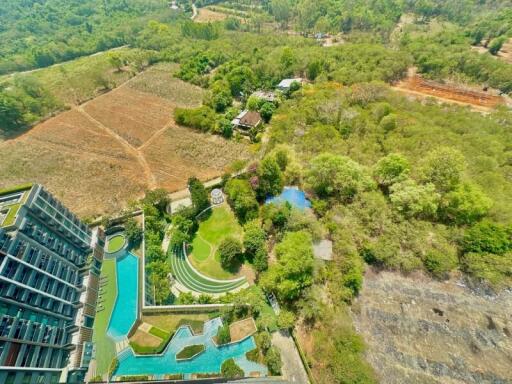 Aerial view of a luxury residential complex with lush greenery