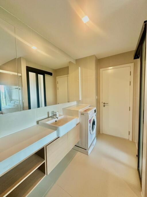 Modern laundry room with washing machine and storage cabinets