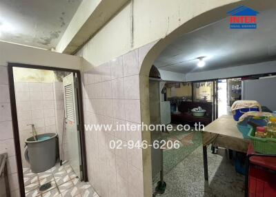 Spacious kitchen with a tiled sink area and arched ceiling
