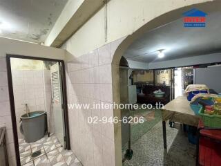 Spacious kitchen with a tiled sink area and arched ceiling