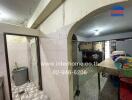 Spacious kitchen with a tiled sink area and arched ceiling