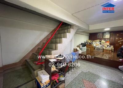 cluttered storage space under staircase in a building
