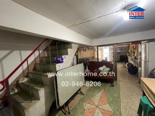 Spacious living room with staircase and classic furnishings