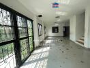 Spacious and sunlit vacant living room with large windows