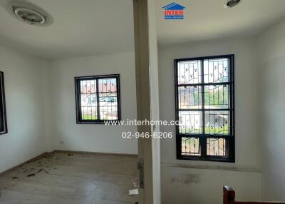 Spacious unfurnished living room with large windows