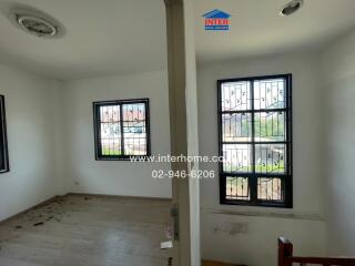 Spacious unfurnished living room with large windows