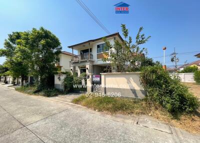 Suburban two-story house with garden and fence