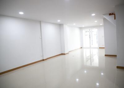 Spacious and brightly lit empty room with glossy white tiles