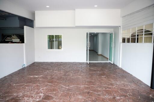 Spacious and well-lit empty main living area with marble flooring