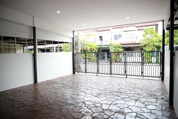 Spacious garage area with covered roof and stone flooring