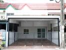 Front view of a modern residential house with gated entry