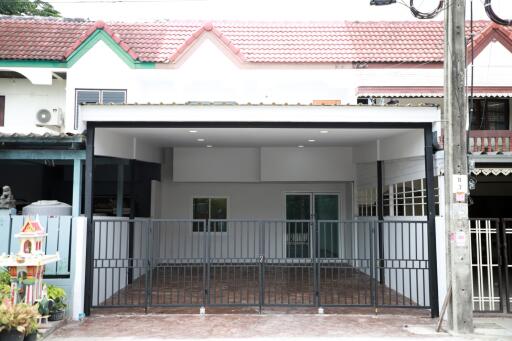 Front view of a modern residential house with gated entry