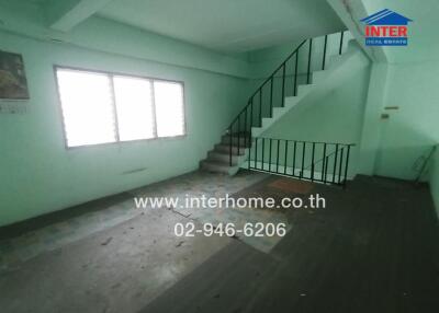 Spacious unfurnished multi-level room with staircase