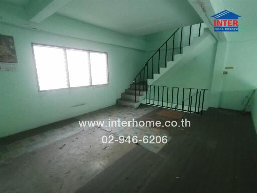 Spacious unfurnished multi-level room with staircase