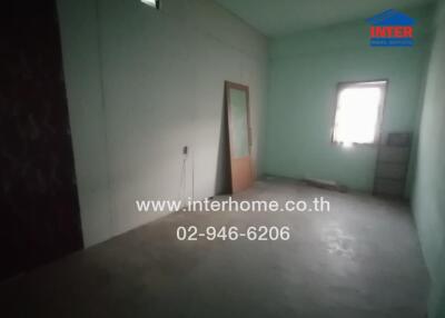 Unfurnished bedroom with pale green walls and window