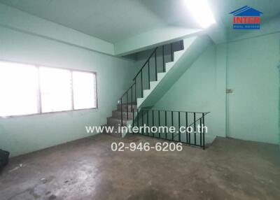 Spacious interior room with staircase