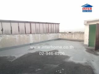 Spacious roof terrace with safety railings and concrete flooring