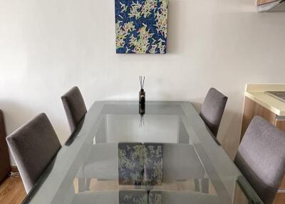 Modern dining room with glass table and artwork