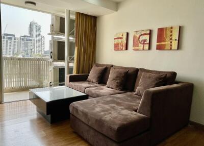 Modern apartment living room with large sofa and city view