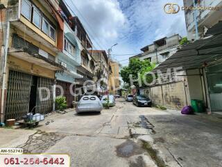 View of a street with residential buildings and parked cars