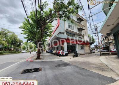 Building exterior view with tree and parked motorcycles