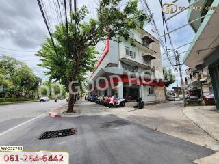 Building exterior view with tree and parked motorcycles