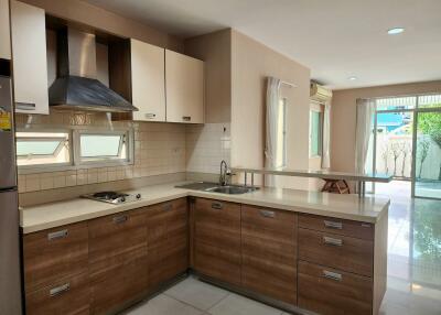 Spacious modern kitchen with wooden cabinets and natural light