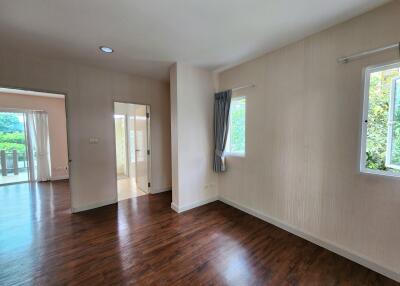 Spacious unfurnished living room with wooden flooring and good natural light