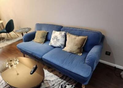 Cozy living room with blue sofa and golden coffee table