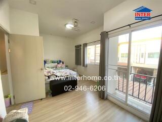 Spacious bedroom with large windows and ample natural light