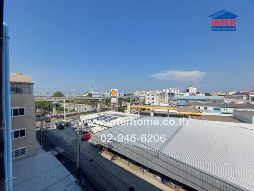 View from apartment building showing surrounding area with industrial and residential buildings