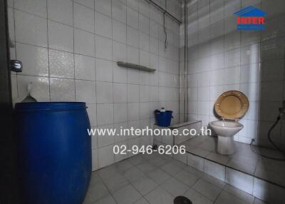 Bright and spacious bathroom with white tiling and essential fixtures