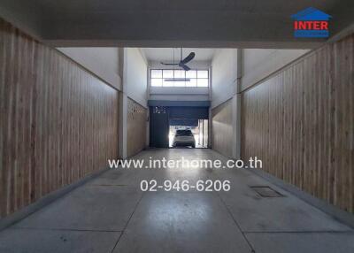 Spacious garage interior with wooden walls and natural light