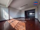 Spacious living room with natural lighting and hardwood floors