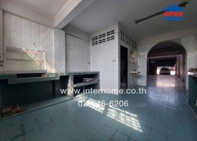 Spacious kitchen with large windows and tiled flooring