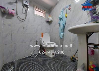 Spacious tiled bathroom with modern fixtures