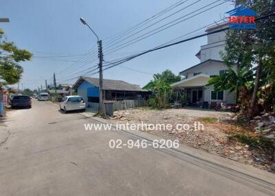 Quiet residential street with houses and parked cars