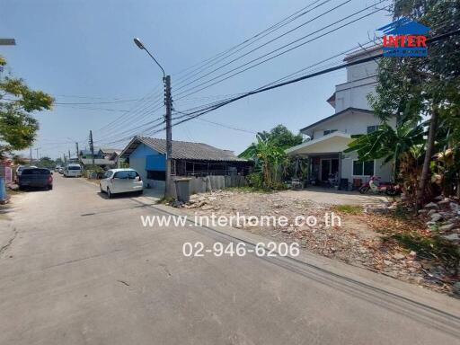 Quiet residential street with houses and parked cars