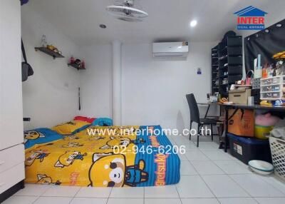 Compact bedroom with bed on the floor, air conditioning unit, and storage shelves