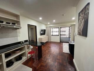 Spacious and well-lit living room with integrated kitchen