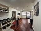 Spacious and well-lit living room with integrated kitchen