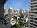 Panoramic city view from high-rise balcony