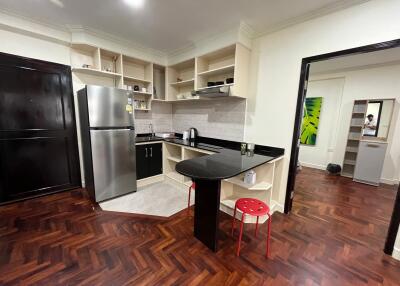 Spacious modern kitchen with stainless steel appliances and herringbone wood flooring