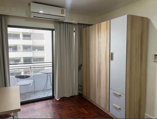 Modern bedroom with balcony access and ample natural light