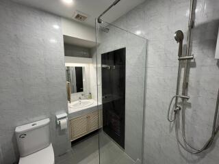 Modern bathroom with glass shower and bright lighting